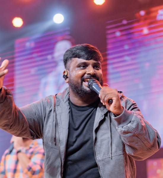 Selvam live performance with colorful stage lighting
